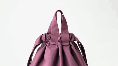Cos bag, Dh257: A softly structured, cotton drawstring bag that can be worn in multiple ways. The burgundy shade is a knockout. This bag can be worn to your next weekend trip, or just as a winsome alternative to dull office backpacks