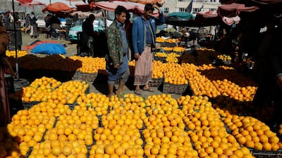 Yemenis shop for oranges at a wholesale market in Sanaa. EPA