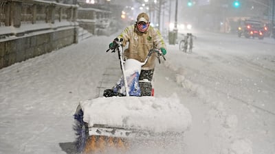 A man clears snow as snow falls near Bryant park during a Nor'easter, during the coronavirus pandemic in the Manhattan borough of New York City. Reuters
