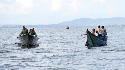 Rescuers search for passengers from a pleasure a boat that capsized in Lake Victoria off Uganda's Mukono district on November 25, 2018. Reuters