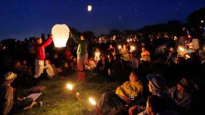 Glastonbury Festival may be changing but the thousands of people who attend, like this group sitting amid candles and a paper lantern, it is about more than the music.