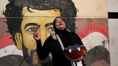 Hajja Dalal, a 46-year-old Mesaharati, beats a drum to wake up Muslims to have the predawn meal before they start their long-day fast, during Ramadan at Maadi neighbourhood in Cairo, Egypt. Reuters