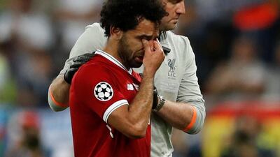 Mohamed Salah breaks down in tears after an injury forced his withdrawal from the Uefa Champions League final. Andrew Boyers / Reuters