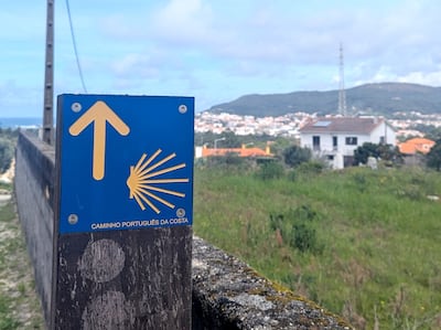 The clam is a symbol of the Camino De Santiago, and pilgrims can navigate their way to the cathedral by following the yellow arrows and shells along the path. Hayley Kadrou / The National