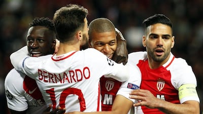Monaco's Kylian Mbappe, second from right, is embraced by teammates after scoring his side's first goal against Borussia Dortmund on Wednesday. Sebastien Nogier / EPA