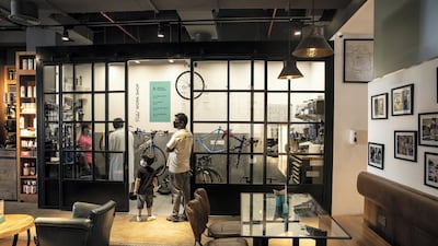 A customer's measurements are used to create the personalised cycle frame, with the final assembly taking place within a glass-walled workshop in the cafe