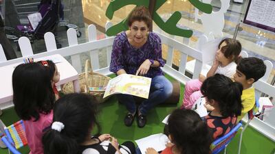 Leonara Pacini reads an educational story to youngster’s at a The Childhood Carnival at Mirdif City Centre, an event designed to to teach children about threats to their safety and risks of abuse. Sarah Dea / The National