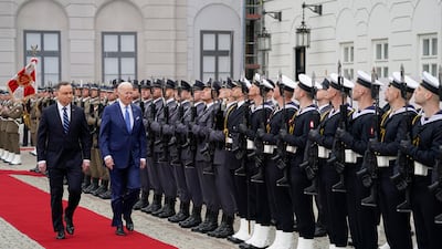 Mr Biden inspects a guard of honour with Mr Duda at the Presidential Palace. AP