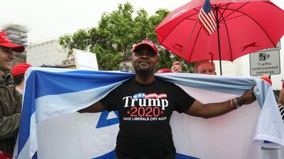 A Trump supporter is wrapped in an Israeli flag as they counter a demonstration against the state visit in central London on June 4, 2019. AFP