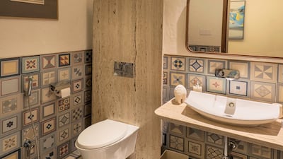 A bathroom with decorative glass and tilework 