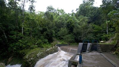 Up to 300 homes at Kamanggih village in Sumba island have access to 24-hour electricity produced by a small hydroelectric generator in the river, above. Romeo Gacad / AFP