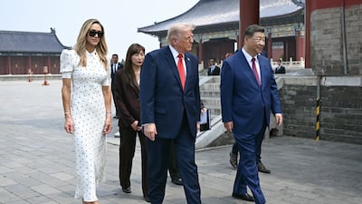 Donald Trump and Xi Jinping walk with Lara Trump during their visit to the Temple of Heaven in Beijing. Getty Images