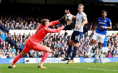Everton goalkeeper Jordan Pickford gathers from Tottenham's Harry Kane, centre. Jason Cairnduff / Reuters