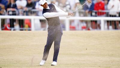 Tiger Woods of the US plays from the first fairway on Day One of The Open at the Old Course, St Andrews. His shot landed in the Swilcan Burn and he ended up shooting a double-bogey six. PA