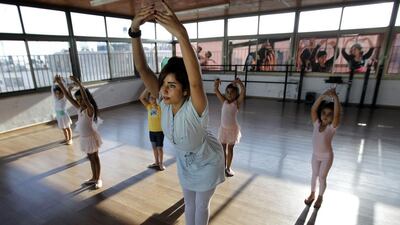 Palestinian ballet teacher Shireen Ziyadeh, centre, teaching her young students how to dance ballet. Abbas Momani/ AFP Photo