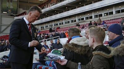 Manchester United's Louis van Gaal signs autographs at Upton Park before his side drew West Ham United 1-1 on Sunday. Adrian Dennis / AFP / February 8, 2015