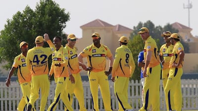 Chennai Super Kings (in yellow) and Kolkata Knight Riders teams in a practice session on Monday at Zayed Cricket Stadium External grounds in Abu Dhabi. Ravindranath K / The National