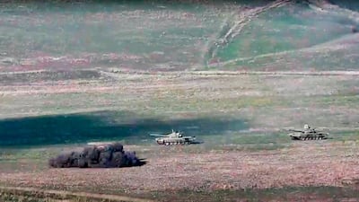 In this image taken from a footage released by Armenian Defense Ministry, Armenian army destroys Azerbaijani tanks at the contact line of the self-proclaimed Republic of Nagorno-Karabakh, Azerbaijan. AP