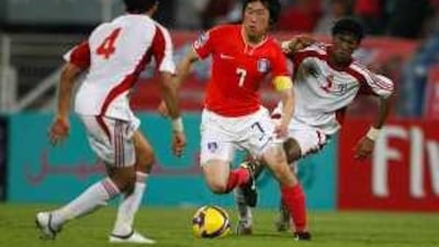 South Korea's Park Ji Sung, centre, swerves in between the UAE's Mohammed Qassim, left, and Fares Juma, right.