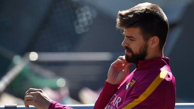 Barcelona’s defender Gerard Pique arrives for a training session at the FC Barcelona Joan Gamper Sports Centre in Sant Joan Despi, near Barcelona on April 16, 2015, on the eve of the La Liga match FC Barcelona v Valencia CF. AFP / LLUIS GENE