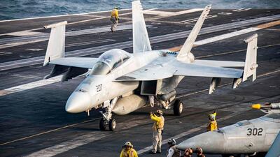 An F/A-18F Super Hornet manoeuvres on the flight deck of the aircraft carrier USS Abraham Lincoln in the Arabian Sea. AFP