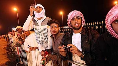 One driver goes through his manoeuvres, top, while spectators watch the competition on Jebel Hafeet yesterday.