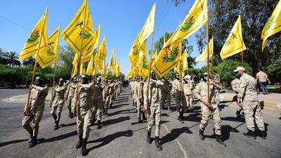 Fighters of Al Nujaba carry their flags and march during an anti-Israel rally in Baghdad, 2019. EPA