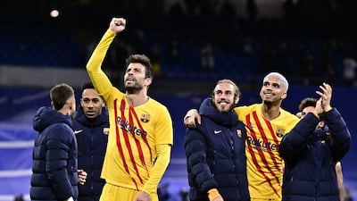 Gerard Pique, left, and teammates celebrate at the end of their match against Real Madrid at the Santiago Bernabeu on March 20, 2022. AFP