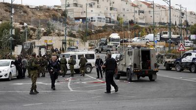 Israeli troops stand guard after a Palestinian was shot by Israeli soldiers at the entrance to Kiryat Arba settlement in the west bank city of Hebron. EPA