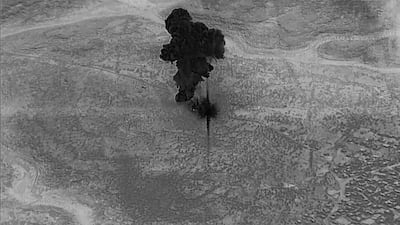 A smoke cloud rises moments after an air strike on the compound of ISIS leader Abu Bakr Al Baghdadi in the Idlib region of Syria in a still image from video. Reuters