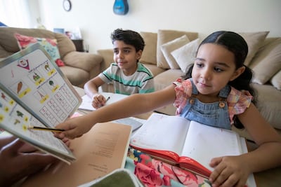 Sibling Mourad 8 and Laila 6 are doing their Arabic summer work at home with their mother Amira (not in picture). Ruel Pableo for The National