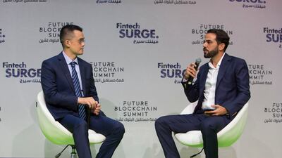 Changpeng Zhao, chief executive of Binance, Gabriel Abed, Barbados' Ambassador to the UAE, during the AI Everything summit at Gitex Global in Dubai on Monday. Leslie Pableo/The National