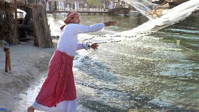 Abdullah Mohammed shows the technique of casting a fishing net during the Qasr al Hosn Festival. Delores Johnson / The National