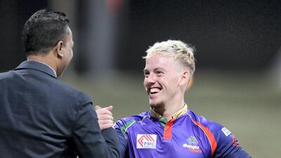 Bangla Tigers batsman Tom Moores celebrates after scoring 28 runs off 9 balls to clinch victory.. Chris Whiteoak / The National
