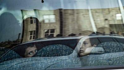 Thirty-four children, the orphans of suspected ISIS fighters, were handed to a Russian delegation by Syrian Kurdish officials in Qamishli, Syria, on Sunday. AFP