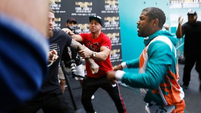 Floyd Mayweather and Jake Paul scuffle after Paul took Mayweather's hat during a media day for Mayweather's fight against Logan Paul. AFP