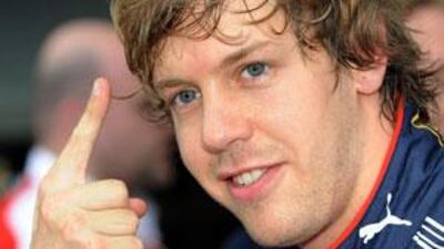 Red Bull Racing's Sebastian Vettel of Germany gestures 'number one' after setting the fastest time during the qualifying session for Formula One's Australian Grand Prix in Melbourne.