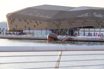 A giant bronze sculpture emerges from the water at Yas Bay Waterfront. Khushnum Bhandari / The National