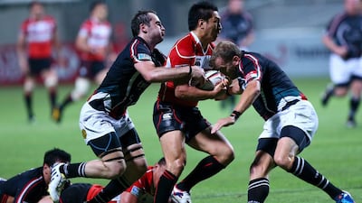 Seiichi Shimomura, centre, is part of a Japan squad that is the gold standard for sides such as the UAE, here in a Asian Five Nations rugby match at Dubai on May 10, 2013 and Singapore aspire to reach. Marwan Naamani / AFP