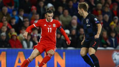 Wales striker Gareth Balem left, dribbles past Croatia midfielder Ivan Rakitic during the Euro 2020 qualifier at Cardiff City Stadium. The match ended 1-1. AFP