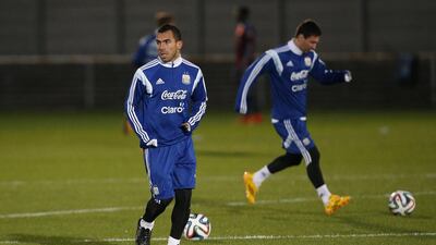Argentina forward Carlos Tevez, left, takes part in a training session at Rush Green Training Ground in Romford, east London, on November 11, 2014 ahead of Argentina's friendly against Croatia. Justin Tallis / AFP