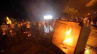 Lebanese demonstraters set a rubbish container on fire during clashes with security forces following a demonstration, organised by the “You Stink” campaign, against the ongoing waste crisis. Thousands of protesters, including children, gathered to protest the Lebanese government’s inability to find a lasting solution to the country’s worsening waste problem. Anwar Amro / AFP