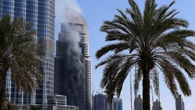 The fire at The Address Downtown Dubai hotel smolders on New Year's Day. Pawan Singh / The National