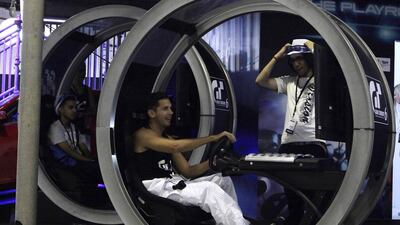 Gamers get a chance to try out Gran Turismo 6 on yesterday’s opening day of the Game 13 event at Dubai World Trade Centre. Jeffrey E Biteng / The National
