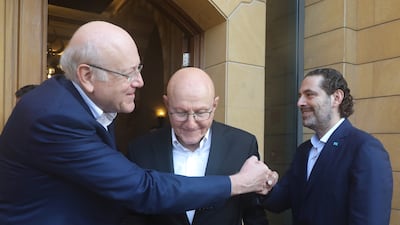 Najib Mikati and Saad Hariri greet each other in Beirut as fellow former prime minister Tamam Salam looks on.