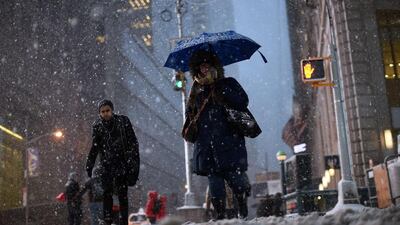 Commuters make their way in New York’s Times Square during the Juno snowstorm. Janua Jewel Samad / AFP