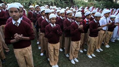 Pakistani students in Karachi pray. Fareed Khan / AP Photo