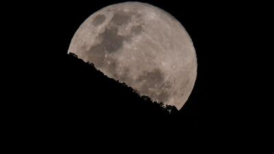 The moon is photographed while rising behind El Avila hill on the sky of Caracas, Venezuela. AFP