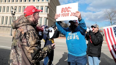 A U.S. President-elect Joe Biden's supporter argues with two U.S. President Donald Trump's supporters as the Board of State Canvassers meet to certify the results of the election in Lansing, Michigan. Reuters