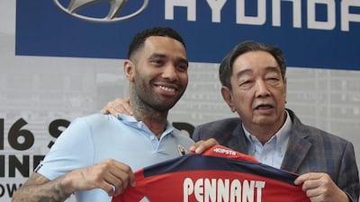 Jermaine Pennant, left, poses with his Tampines Rovers FC kit next to club advisor Teo Hock Seng during a signing ceremony in Singapore, 19 January 2016. EPA/WALLACE WOON
